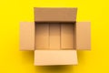 Top view empty brown post or carton box on yellow paper background Royalty Free Stock Photo