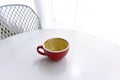 top view of empty cup red of coffee on table white in cafe morning, beautyful light. concept of dirty empty coffee cup after drink Royalty Free Stock Photo