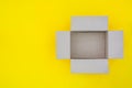 Top view of empty open brown paper cardboard box isolated on yellow background, copy space, flat lay Royalty Free Stock Photo