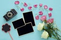 Top view of empty photo frames next to old camera and roses Royalty Free Stock Photo