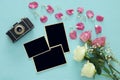 Top view of empty photo frames next to old camera and roses Royalty Free Stock Photo