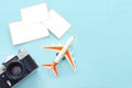 Top view of empty photographs frame next to airplane and camera over wooden table. traveling concept. ready to mock up Royalty Free Stock Photo