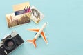 Top view of empty photographs next to airplane and camera over wooden table. traveling concept. ready to mock up Royalty Free Stock Photo