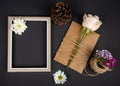 top view of an empty picture frame and brown paper greeting card with white color rose tied with a rope and turkish carnation with