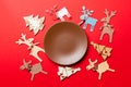 Top view of empty plate and New Year decorations on colorful background. New year serving for festive dinner. Reindeer and Royalty Free Stock Photo