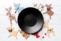 Top view of empty plate and New Year decorations on wooden background. New year serving for festive dinner. Reindeer and Christmas Royalty Free Stock Photo