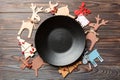 Top view of empty plate and New Year decorations on wooden background. New year serving for festive dinner. Reindeer and Christmas Royalty Free Stock Photo