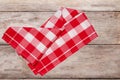 Top view of a empty red and white checkered kitchen cloth, textile, tablecloth or napkin on blurred wooden background. Template Royalty Free Stock Photo