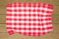 Top view of a empty red and white checkered kitchen cloth, textile, tablecloth or napkin on blurred wooden background. Template Royalty Free Stock Photo