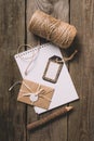 top view of empty textbook tree pencil tag wrapped letter and beige string on wooden