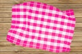 Top view of a empty violet and white checkered kitchen cloth, textile, tablecloth or napkin on blurred wooden background. Template Royalty Free Stock Photo