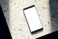 Top view of white smartphone on spotted table. Mock up, 3D Rendering Royalty Free Stock Photo