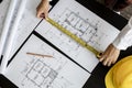 Top view An engineer is using a tape measure to measure the plans of the house that he designs. Royalty Free Stock Photo