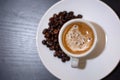 Top view of espresso coffee in a white cup and roasted coffee beans on a saucer Royalty Free Stock Photo