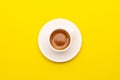 Top view espresso coffee in white cup on yellow Royalty Free Stock Photo