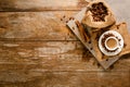 Top view of espresso on grey tile with coffee bean bag and cinnamon on wood background Royalty Free Stock Photo