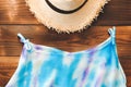 Top view essential travel items Hat and blue tank top on old wooden background. tourism and trip vintage.