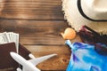 Essential travel items passport, airplane, Hat, money, Sandals, shells on old wooden background. tourism and trip vintage Royalty Free Stock Photo