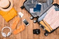 Top view of essentials for tourist with clothes, accessories and gadgets, wallet, passport, smartphone in bag. Royalty Free Stock Photo