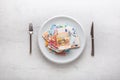 Top of view euro banknotes on white plate with fork and knife