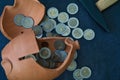 Top view of euro coins in a broken pottery money bank Royalty Free Stock Photo