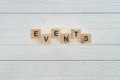 top view of events word made of wooden blocks on white wooden surface