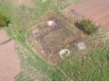 Top view of the excavated foundation of the future buildings with heaps of rubble.