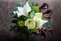 Top view on exquisite bouquet made from white lily, purple calla, and fresh greenery Royalty Free Stock Photo