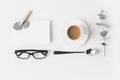 Top view of eyeglasses, cup of coffee, napkin and plant