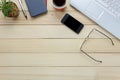 Top view eyeglasses,pen,black coffee,cactus, watch,Laptop,stationary,notebook on office desk background.