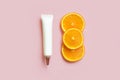 Top view of face and eye cream squeeze natural cosmetic tube with long nozzle and bronze screw cap. Three d orange and white