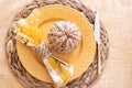 Top view of a fall table setting with yellow plate and wicker pumpkin Royalty Free Stock Photo