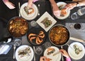 Top view of family eating Spanish Tapas around a white table from high view angle Royalty Free Stock Photo