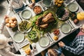 top view of family having holiday dinner with delicious turkey