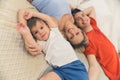 Top view of a family of three - caucasian preschooler boy in white t-shirt, his beautiful blond mother in light blue Royalty Free Stock Photo