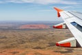 Top view of the famous Uluru monolith flying over the area with an airliner, Ayers Rock, Northern Territory, Australia