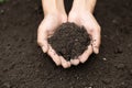 Top view. Farmer holding soil in hands. The researchers check the quality of the soil. Agriculture, gardening or ecology concept