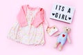 Top view fashion trendy look of baby girl clothes and toy stuff. Babyshower concept Royalty Free Stock Photo