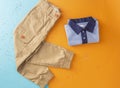 Top view fashion trendy look of boys clothes and shoes, fashion concept, outfit, colors background, Stylish child look. Royalty Free Stock Photo