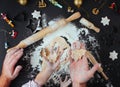 Top view of fathers and kids hands making Christmas tree cookies Royalty Free Stock Photo