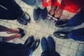 Top view of feet of fashionable, stylish people standing in a circle Royalty Free Stock Photo