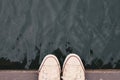 Top view feet of hipster women on wood and water background