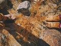 Top view of feet of young couple on dry golden grass