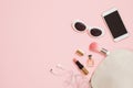 Flat lay female accessories cosmetics sunglasses mobile phone headphones makeup on pastel pink background. Valentine`s Day 8 March