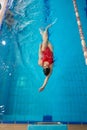 Caucasian sportswoman swimming on back in water Royalty Free Stock Photo