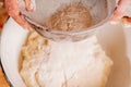 Top view of female baker prepares the dough for baking on kitchen wooden table Royalty Free Stock Photo