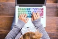 Top view of female caucasian hands working on coloured keyboard of laptop computer - concept of connected people and smart