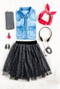 Top view of female clothes. A collage of woman tull skirt, denim shirt and accessories. Fashionable urban outfit. Royalty Free Stock Photo