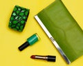 Top view of female fashion accessories . Green handbag with lipstick and bracelet Royalty Free Stock Photo