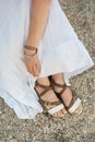 Top view of female feet in sandals on sand beach. Vertical frame Royalty Free Stock Photo